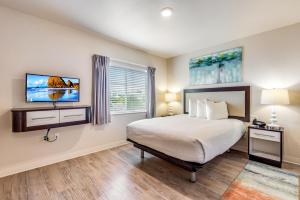 a bedroom with a bed and a tv on the wall at Parks Residential Denver in Centennial