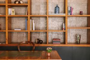 a wooden shelf with a table and a vase of flowers at Salute Palace powered by Sonder in Venice