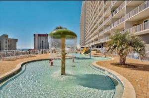 a fountain in a pool in front of a building at Spectacular 5th Floor Gulf View Condo in Panama City Beach, just steps away from the beach in Panama City Beach