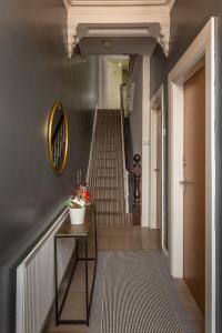 a hallway with a staircase with a person walking up the stairs at 147 The Residence, 5 bedrooms- Free parking in Belfast +26 photos