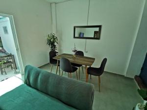 sala de estar con mesa, sillas y sofá en Acogedor departamento en Santa Rosa