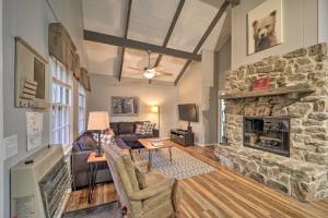 a living room with a large stone fireplace at Pristine Cabin Less Than 2 Mi to Beech Mountain Resort! in Beech Mountain