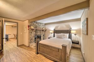 a bedroom with a large bed and a fireplace at Pristine Cabin Less Than 2 Mi to Beech Mountain Resort! in Beech Mountain