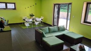 a living room with a couch and a table at Modern Three Bedroom House in Figueiró