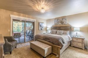 a bedroom with a bed and a sliding glass door at 7th Fairway Getaway in Columbia Falls +80 photos