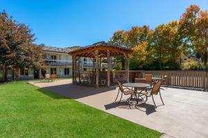 a gazebo with a table and chairs in a yard at Best Western Mountain Lodge At Banner Elk in Banner Elk