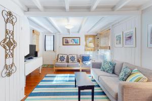 ein Wohnzimmer mit Sofa und Tisch in der Unterkunft Canary Cottage in Oak Bluffs