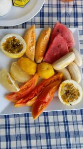 a plate of fruit and vegetables on a table at Tamarind Great House in Oracabessa