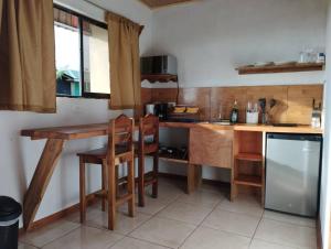 a kitchen with a wooden table and a counter at Siary Aparment con vista 3 in Monteverde Costa Rica +10 photos