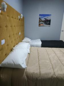 a bedroom with a large bed with a large headboard at Hotel Ruta 66 Oficial in Paso de los Libres