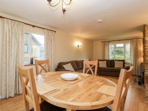 a living room with a table and a couch at Lanes End in Sherborne