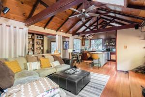 a living room with a couch and a ceiling fan at Tranquil creek mountain house in Los Gatos