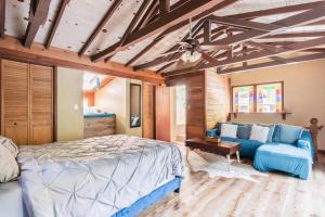 a bedroom with a bed and a couch at Tranquil creek mountain house in Los Gatos