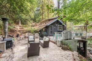 a backyard patio with chairs and a house at Tranquil creek mountain house in Los Gatos