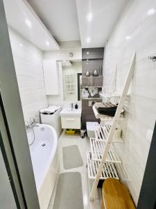 a bathroom with a white tub and a sink at Giżycko Apartament 100m od plaży in Giżycko