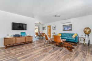 a living room with a blue couch and chairs at Shooting Star Lodge in Joshua Tree