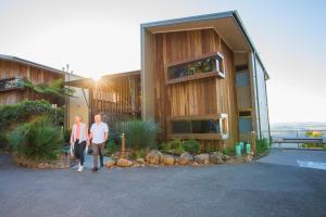 a man and woman standing in front of a house at Binna Burra Sky Lodges in Beechmont
