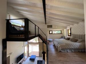 a large room with a bed and a staircase at Complejo EL PAÑIL in Lago Puelo