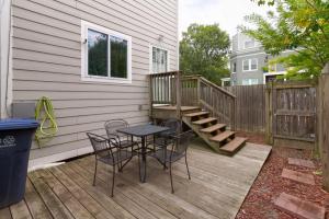 a patio with a table and chairs on a deck at The Gray Corner House by Gallaudet 3 BR 2 BA in Washington