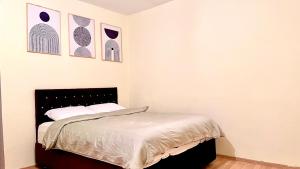 a bedroom with a bed and some pictures on the wall at Akaretler spacious family suitable 6 person flat in Istanbul