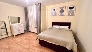 a bedroom with a bed and a dresser and a mirror at Akaretler spacious family suitable 6 person flat in Istanbul