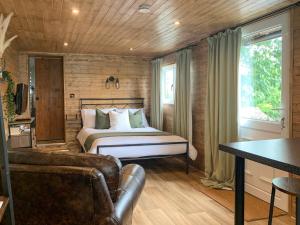 a bedroom with a bed and a couch and a table at Uk41510 - The Cabin in Boyton