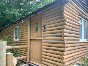 a log cabin with a wooden door on it at Uk41510 - The Cabin in Boyton