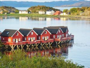 a row of houses on a dock in the water at 6 person holiday home in Brekstad-By Traum in Brekstad
