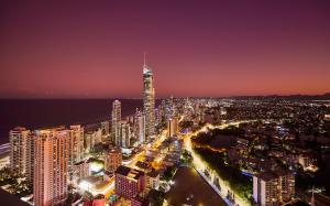 a city skyline at night with a tall skyscraper at Circle on Cavill 2, 3, 4 & 5 Bedroom SkyHomes & SUB PENTHOUSES by Gold Coast Holidays in Gold Coast