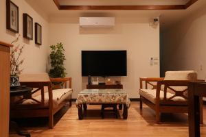 TV a/nebo společenská místnost v ubytování Lemuju B&B Hotel
