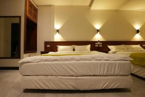 Postel nebo postele na pokoji v ubytování Lemuju B&B Hotel