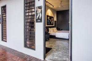 a room with a bed and a room with a mirror at CITY HUNTER At Georgetown in George Town