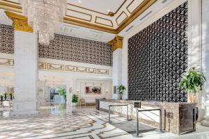 a lobby with a chandelier and a reception desk at Melia Vinpearl Quang Binh in Dong Hoi +41 photos