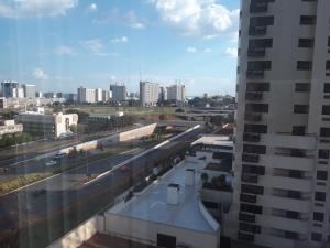 a view of a city with a train station and buildings at Flat sem café da manhã - Cullinan (SHN Brasília) in Brasília