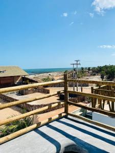 a view of the beach from the balcony of a house at Bali BG Casa Bamboo in Barra Grande