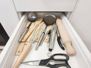 a drawer filled with various kitchen utensils at Brand new stylish 2BR apartment- free parking in Auckland