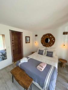 a bedroom with a large bed and a mirror at Maxima Sunset in Sainte-Maxime