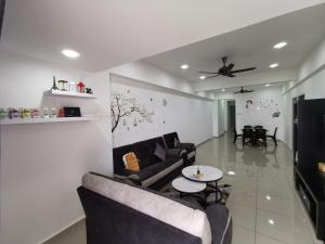 a living room with a couch and a table at Coco HomeStay 旅人の家@The Venus Sitiawan Perak in Sitiawan