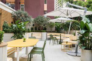 an outdoor patio with tables and chairs and umbrellas at YING'nFLO, Hong Kong, Wan Chai in Hong Kong