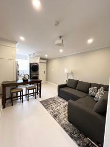 a living room with a couch and a table at SHAK Condos- Luxury, Functionality and Comfort in Saint Helena