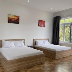 Postel nebo postele na pokoji v ubytování Homestay Tulip Garden Bảo Lộc