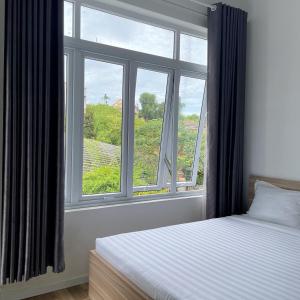 Postel nebo postele na pokoji v ubytování Homestay Tulip Garden Bảo Lộc