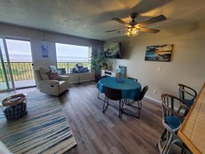 a living room with a table and a couch at Oceanfront Condo at Seaside Beach Club Unit 306 in Seaside