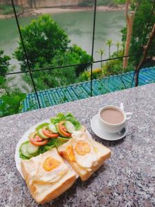 a plate of toast with eggs and vegetables and a cup of coffee at Rosie Villa Ha Giang - Motorbikerental & Tour in Ha Giang