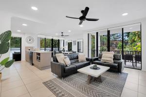 a living room with a couch and a table at Elysium Apartments in Palm Cove