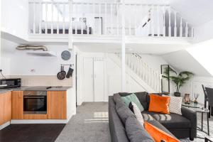 a living room with a couch and a kitchen at Elmsleigh Lofts by Sorted Stay in Southend-on-Sea
