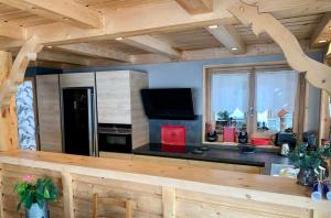 a kitchen with a refrigerator and a counter top at Apartment in Morzine - Ski In - Sleeps 6 in Morzine