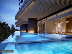 a swimming pool in front of a building at ULTIQA Signature at Broadbeach in Gold Coast