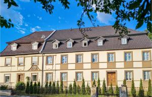 a large tan building with a black roof at Gorgeous Apartment In Lichtenfels Ot Kloster With Wifi 