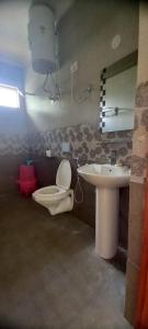 a bathroom with a toilet and a sink at Villa Vikas Studio in Dharamshala